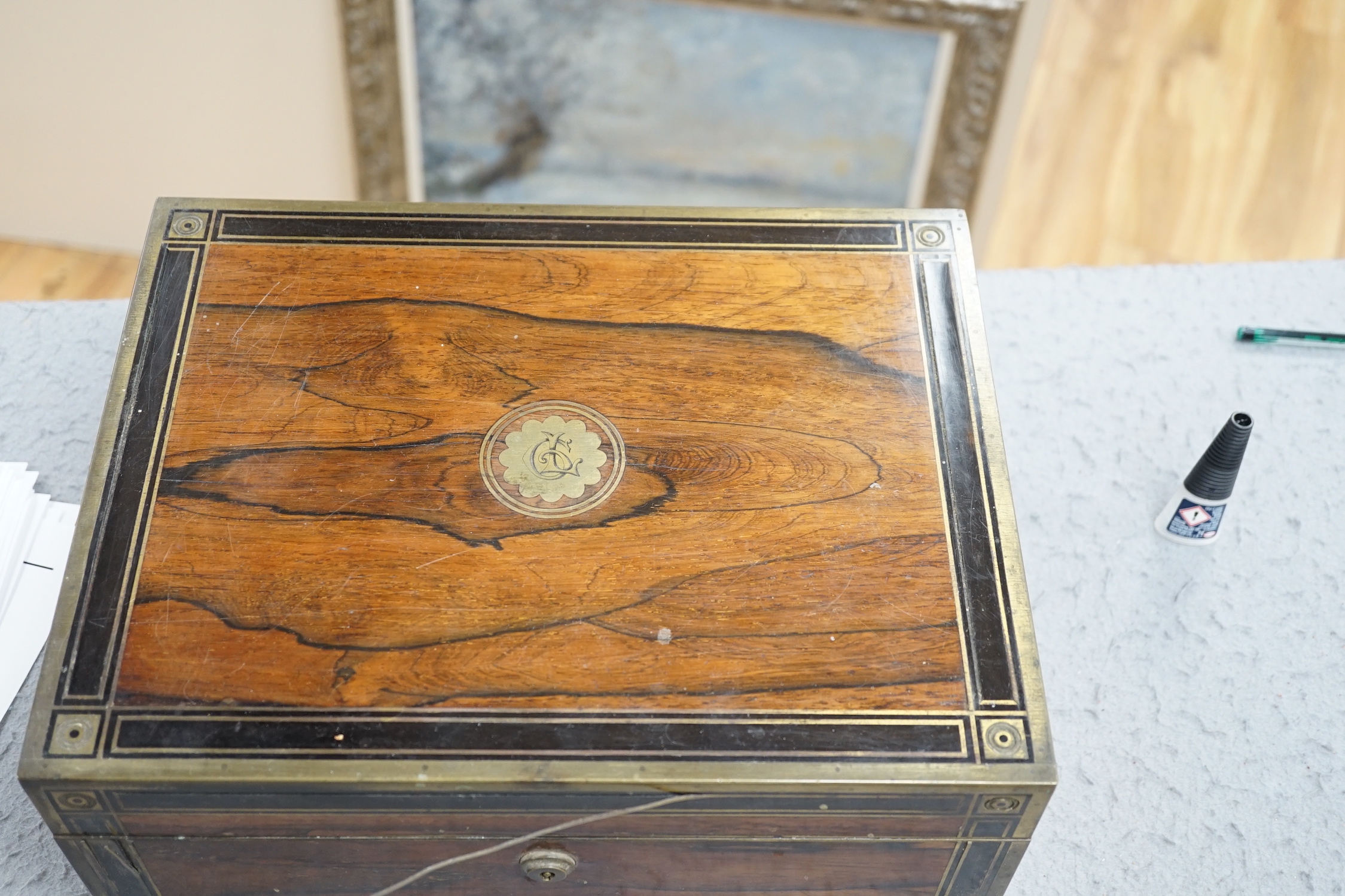 A George IV brass mounted rosewood travelling toilet box, with eleven silver mounted glass toilet jars etc, John & Archibald Douglas, London, 1822, with engraved monograms, four caps unmarked, box 34.1cm.
